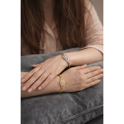 Gold and silver square halo lock bracelets worn on model hands with soft peach nail polish on grey velvet cushion