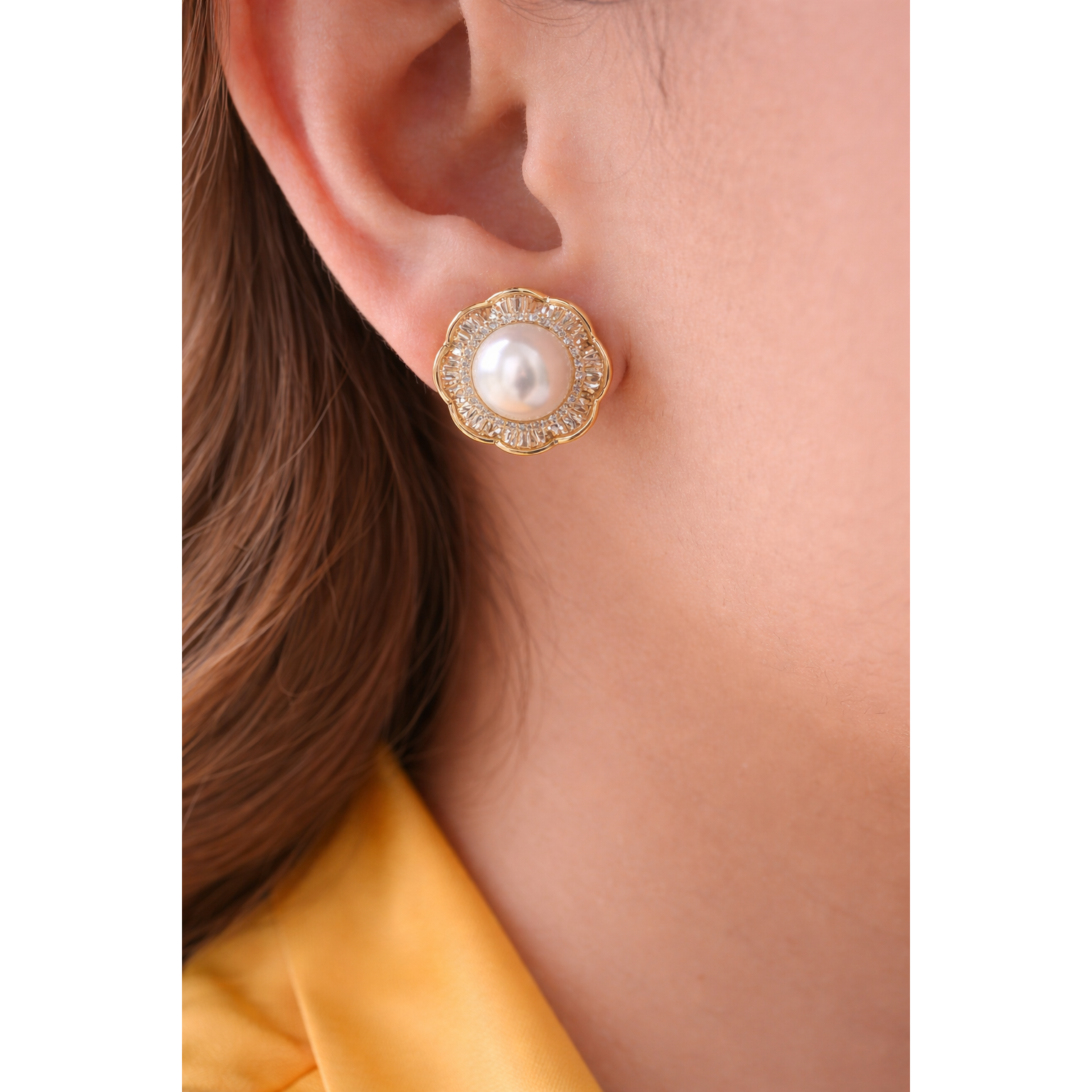 Gold floral halo pearl stud earrings worn on model with mango silk shirt close-up