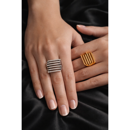 Model wearing gold and silver multi-row pavé bar rings on black satin background