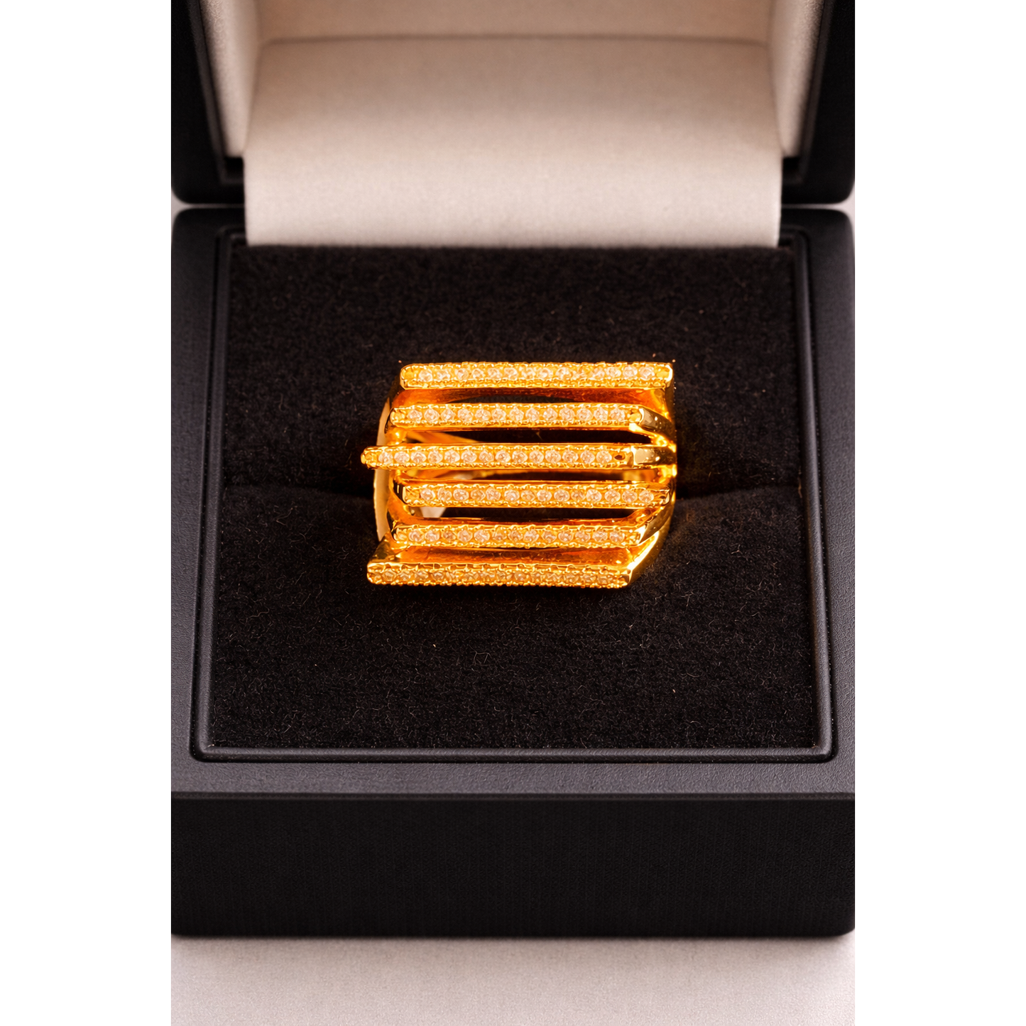 Gold multi-row pavé bar ring displayed in a jewelry box, high-definition studio shot