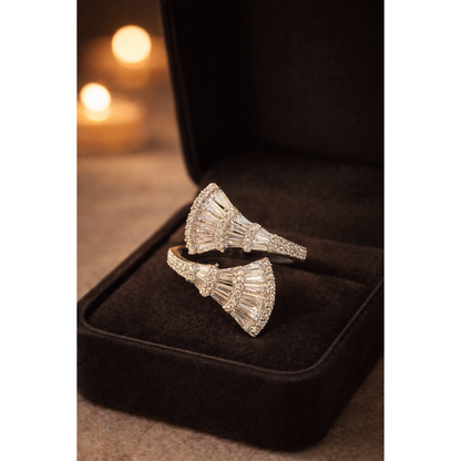 Silver open wrap fan baguette statement ring inside dark jewelry box with warm candlelight background