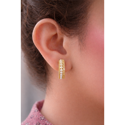 Close side profile of a woman wearing Gold pearl row multi-band hoop earrings with detailed beadwork