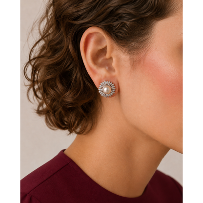 Close-up of pearl sunburst stud earrings worn on ear with silver crystal petals and central pearl