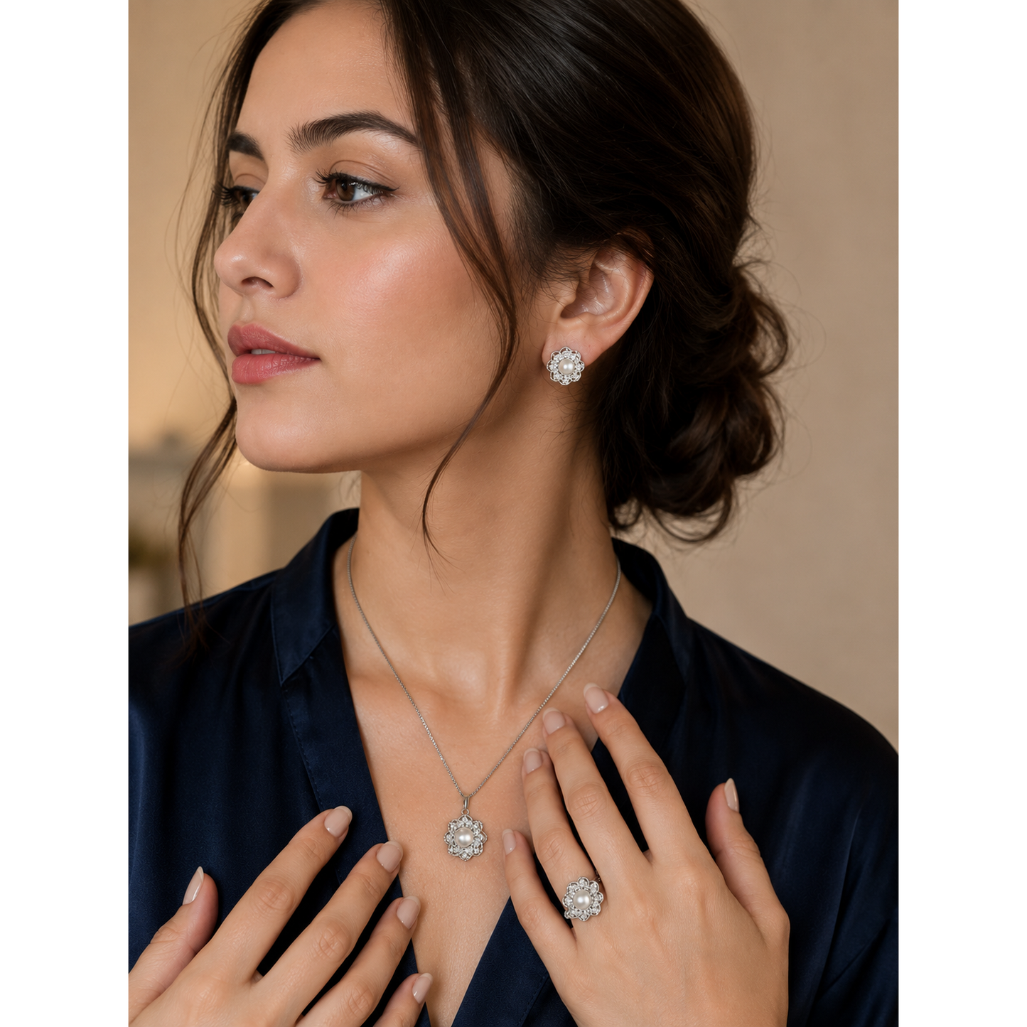 Model wearing silver pearl floral jewelry set with matching pendant necklace, stud earrings, and statement ring in luxury fashion portrait
