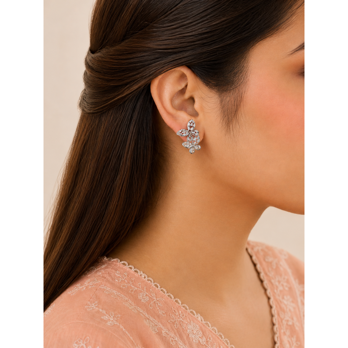 Butterfly design crystal earrings worn on ear with marquise stone wing shape