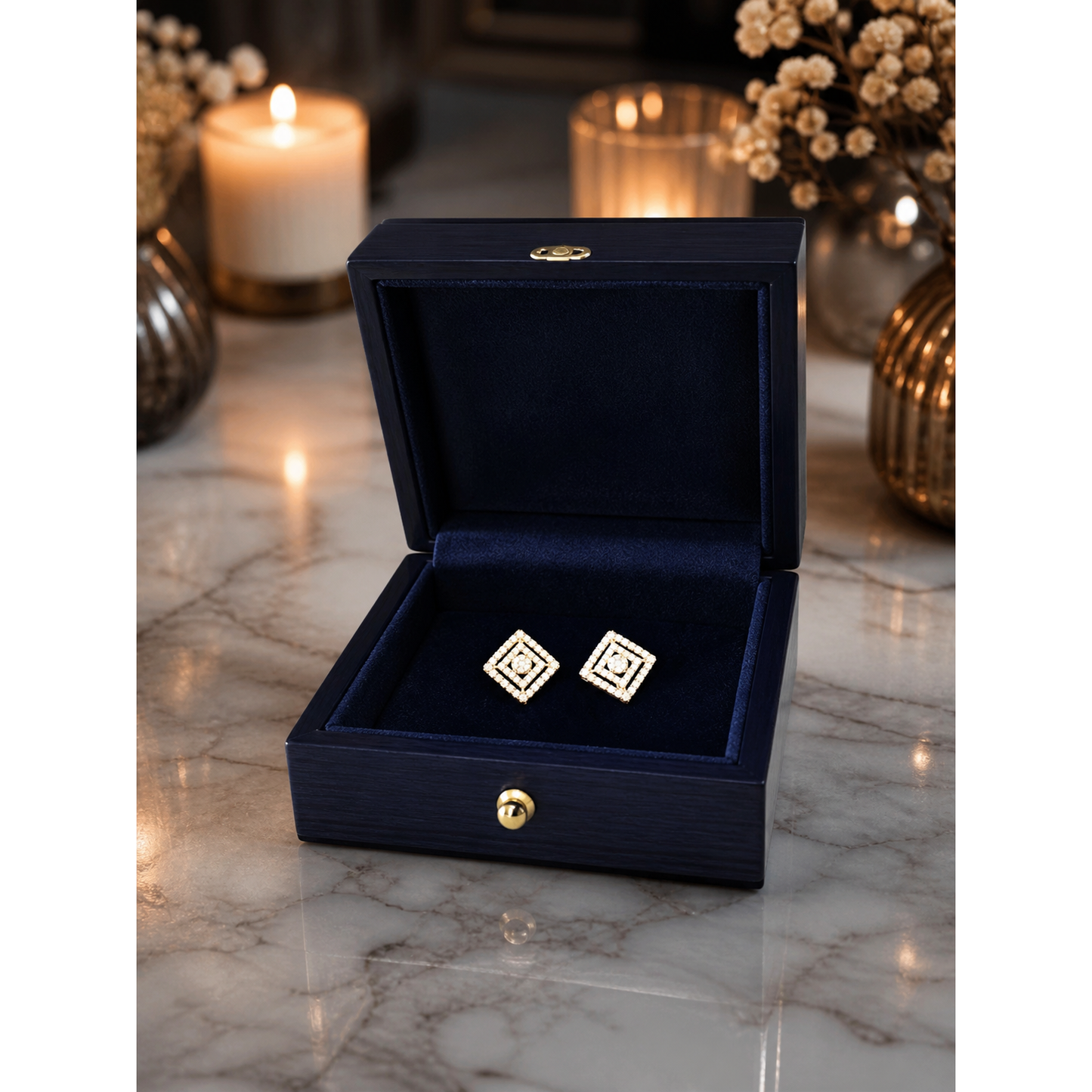 Silver square crystal stud earrings placed inside navy velvet jewelry box on marble surface