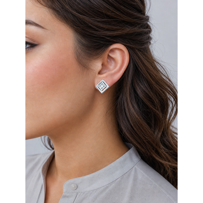 Silver geometric square stud earrings worn on ear with crystal detailing close-up