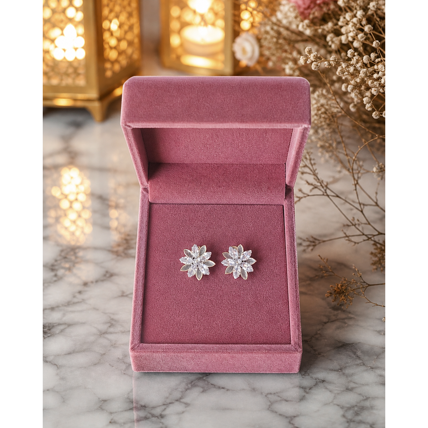 Crystal flower stud earrings placed in dusty rose velvet jewelry box on marble background with soft lighting
