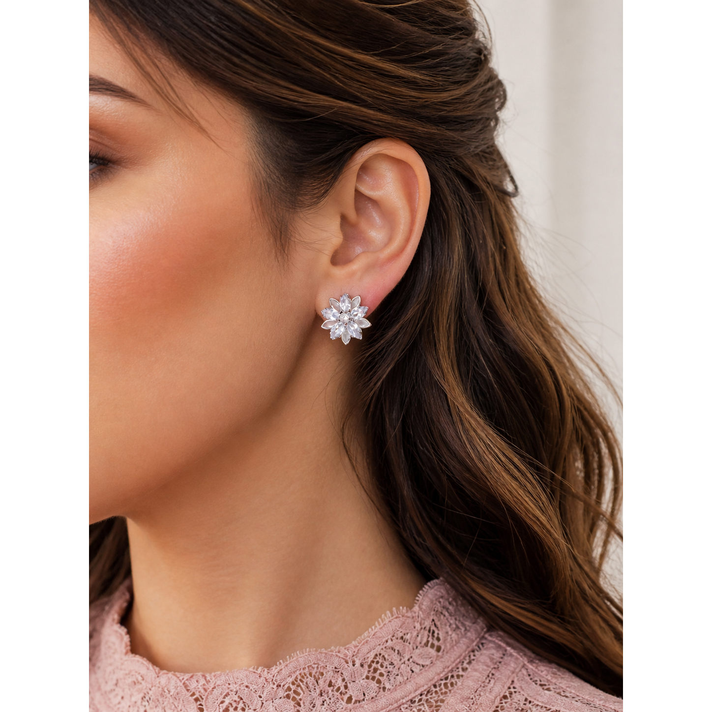 Floral crystal stud earrings worn on ear showcasing petal design with zircon stones and soft sparkle