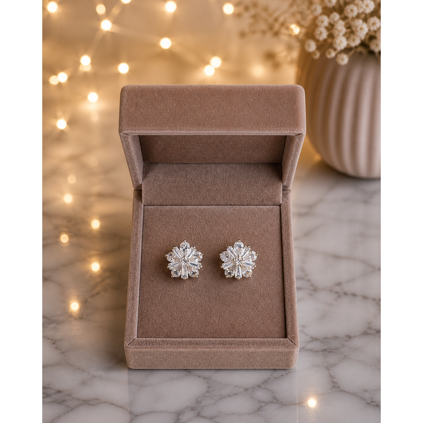 Crystal flower clip-on stud earrings in mocha velvet jewelry box on marble surface with soft lights