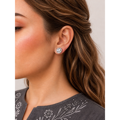 Round halo crystal stud earrings worn on ear showing central zircon stone with surrounding sparkle