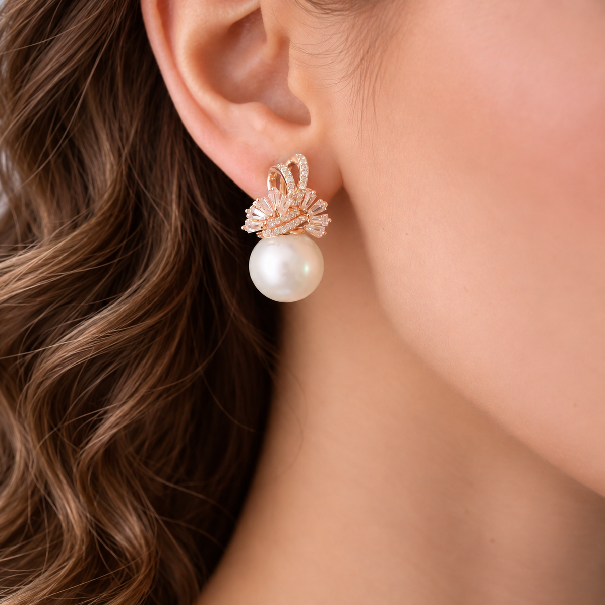 Close-up of model wearing Gilded Fan Pearl Drop earring featuring a crystal fan design and large white pearl.