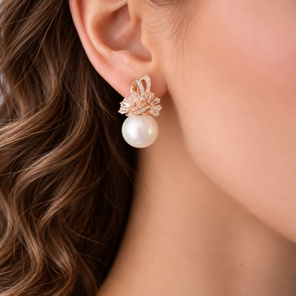 Close-up of model wearing Gilded Fan Pearl Drop earring featuring a crystal fan design and large white pearl.