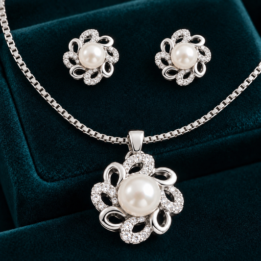 S925 silver pearl loopflower pendant and matching stud earrings displayed on deep teal velvet.