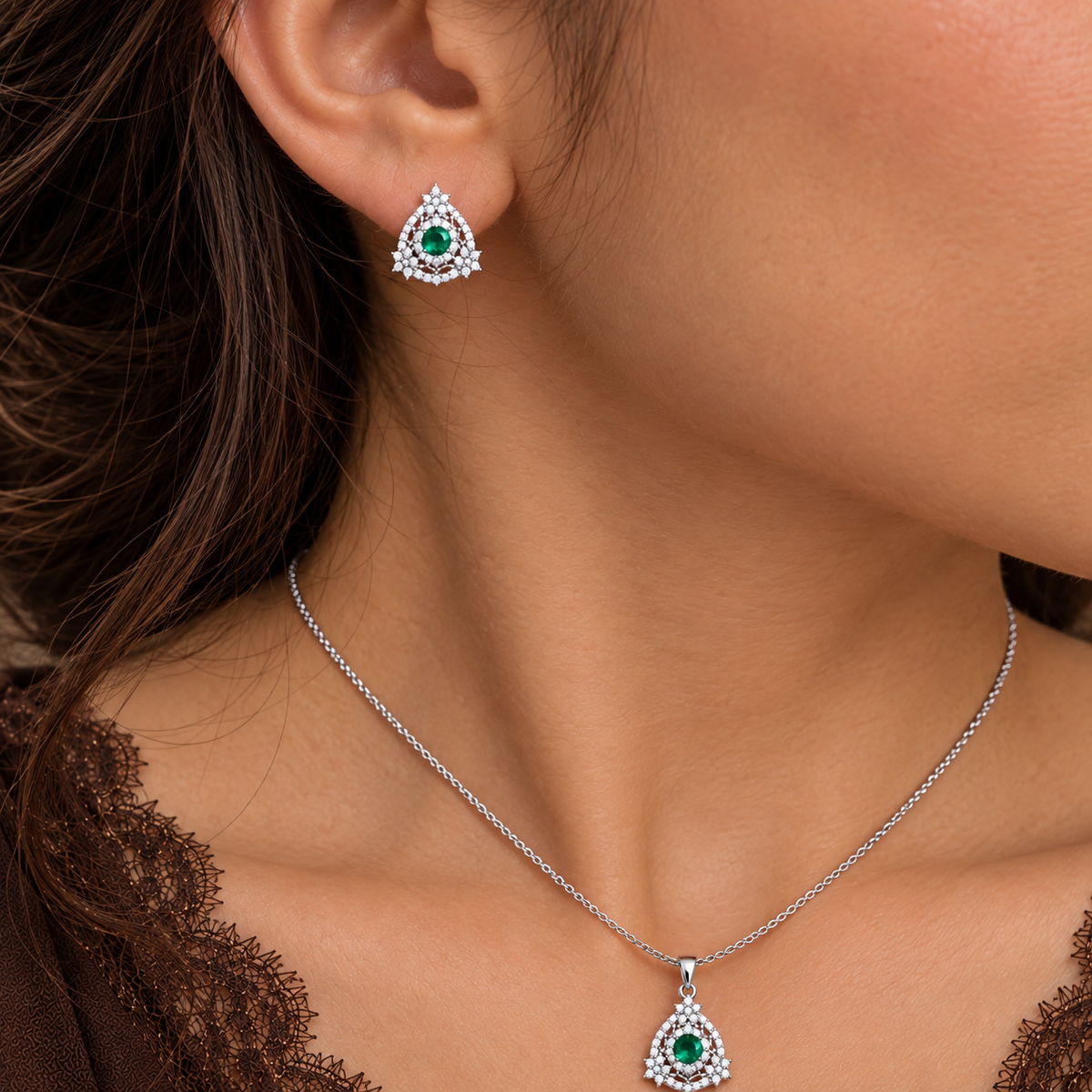 Close-up of model wearing petite S925 emerald-green zircon earrings and matching pendant necklace.