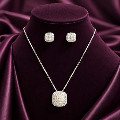 Silver-S925 rounded-square zircon earrings and matching pendant necklace featuring densely set clear stones, displayed on a premium plum jewellery stand.