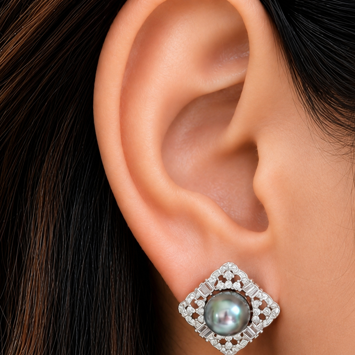 Close-up of Pearl Lattice Stud worn on the ear, featuring a luminous pearl centre surrounded by geometric silver and zircon detailing.
