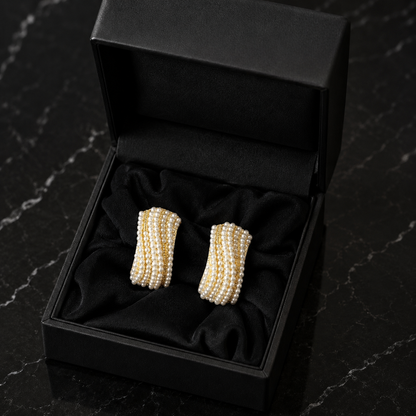 Pearl Ripple Stud Earrings featuring multiple curved rows of petite white pearls with fine gold-tone detailing, displayed in a black jewellery box.