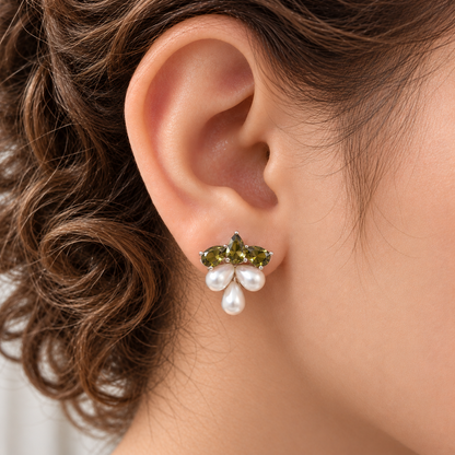 Close-up of Grape Dew Pearl Stud worn on the ear, showing three faceted  olive green crystals and three pearl drops in a compact clustered silhouette.