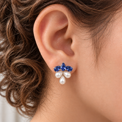 Close-up of Grape Dew Pearl Stud worn on the ear, showing three faceted  blue crystals and three pearl drops in a compact clustered silhouette.