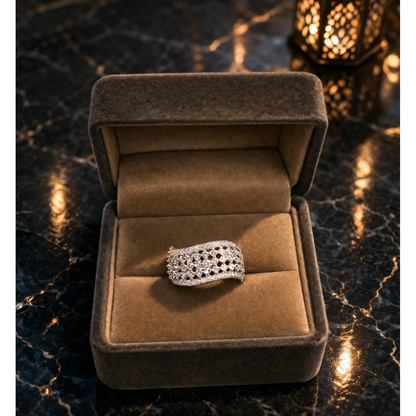 Adjustable silver mesh crystal ring placed in soft velvet jewelry box with warm ambient lighting background