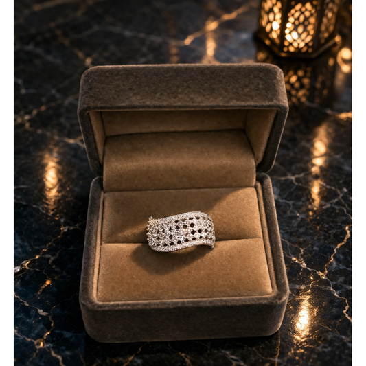 Adjustable silver mesh crystal ring placed in soft velvet jewelry box with warm ambient lighting background
