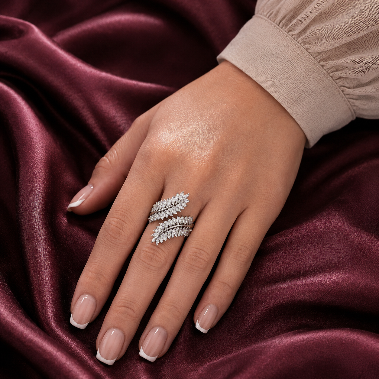 Virelle silver-tone leaf ring worn on the finger, showing its layered clear zircon leaves and sculptural wrap-style design