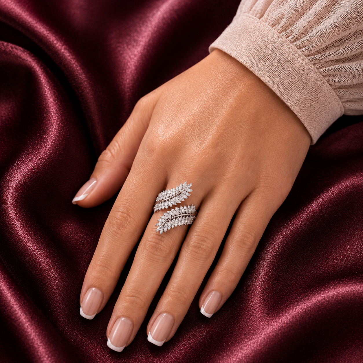 Virelle silver-tone leaf ring worn on the finger, showing its layered clear zircon leaves and sculptural wrap-style design