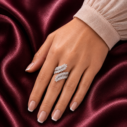 Virelle silver-tone leaf ring worn on the finger, showing its layered clear zircon leaves and sculptural wrap-style design