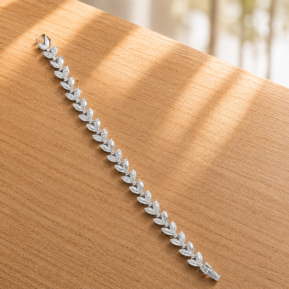 Close-up of Silver Sylvan Bracelet displayed straight , showing polished leaf links and clear zircon detailing.