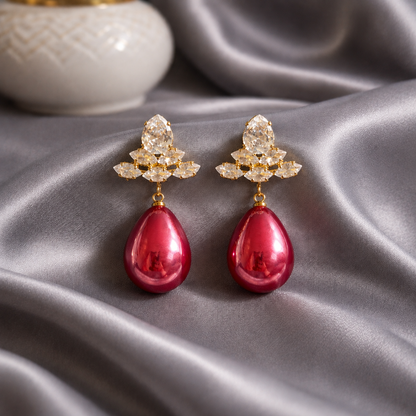 Hot Pink teardrop crystal earrings displayed on grey satin with gold-tone crystal cluster
