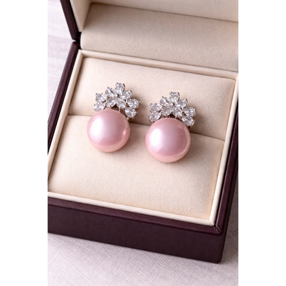 High-definition product photo of floral crystal and pink pearl earrings displayed inside a premium velvet jewelry box