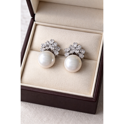 High-definition product photo of floral crystal and white pearl earrings displayed inside a premium velvet jewelry box