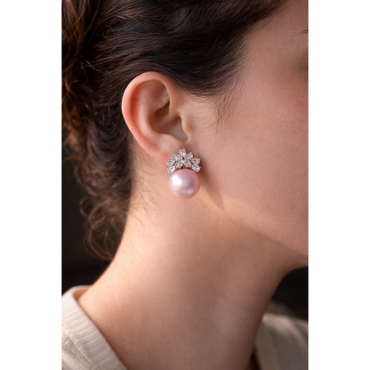 Close-up of a model wearing elegant floral crystal and pearl earrings