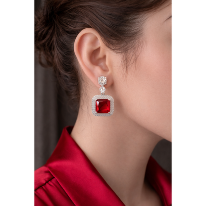 Silver square red stone drop earrings worn by model, bold statement jewellery side profile