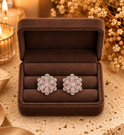 Silver floral crystal stud earrings displayed in premium brown velvet jewelry box with warm luxury styling.