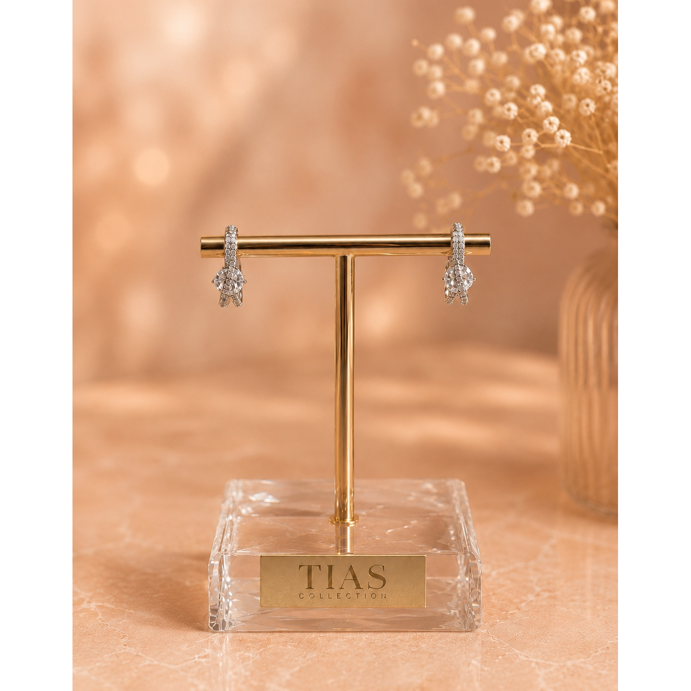 Luxury silver infinity hoop earrings on a premium jewelry display stand with sparkling cubic zirconia and marquise crystal