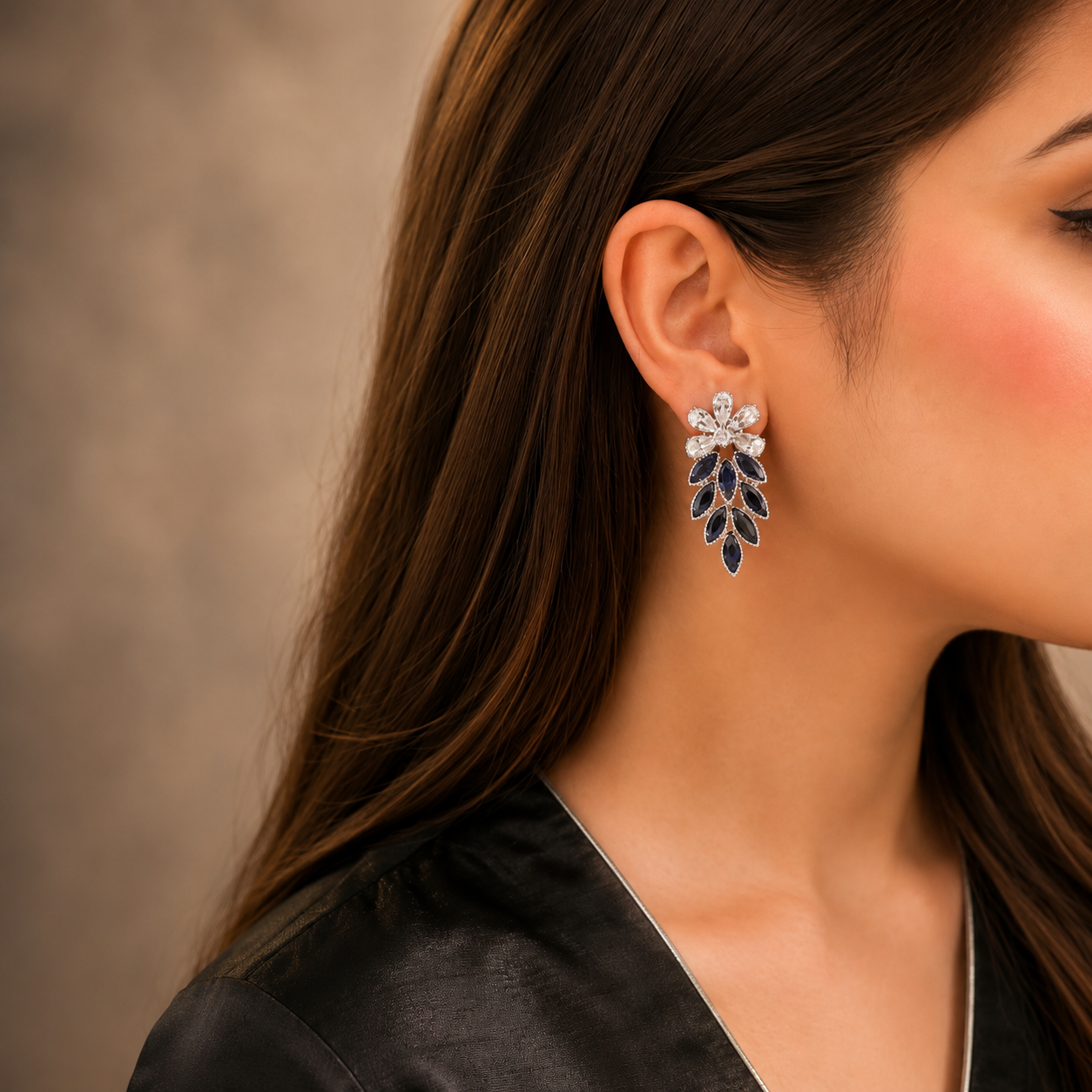 Close-up of a woman wearing a floral earring with a neutral background