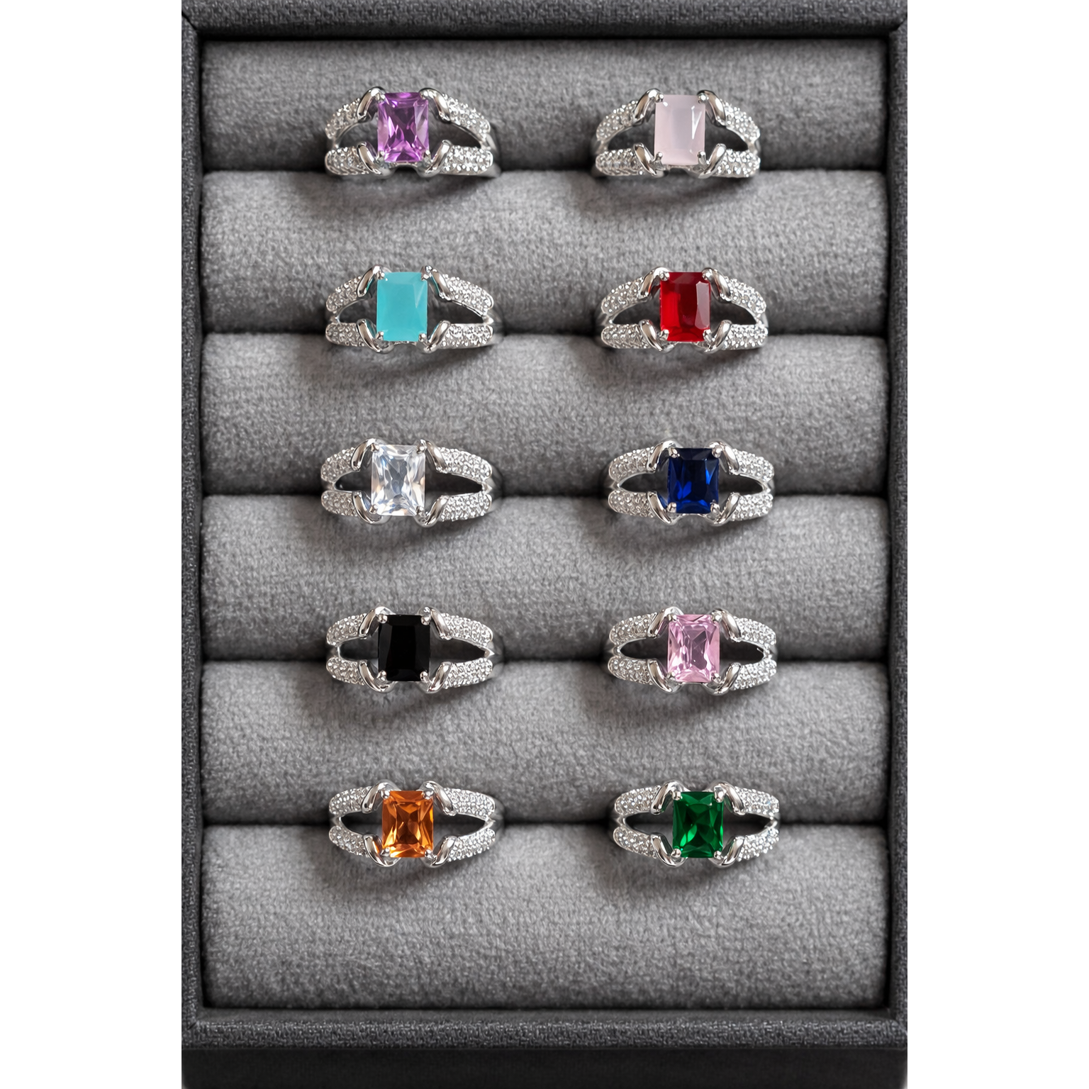 Silver tone adjustable square cut artificial gemstone rings arranged in grey velvet box featuring pink, turquoise, red, blue, green, black and clear stone variants