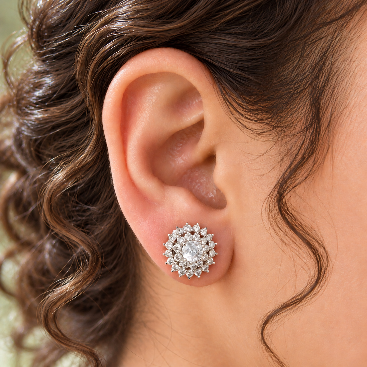 Close-up of a woman's ear wearing a clear Kensington Cluster Stud, showcasing its delicate circular design and neat placement on the earlobe.