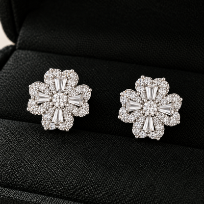S925 silver Prism Clover Studs displayed in a black jewellery box, featuring four sculpted petals with tapered baguette and clear zircon detailing.