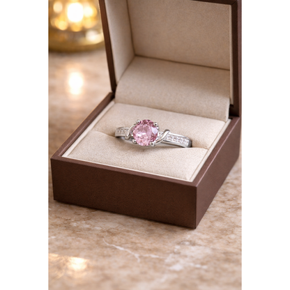 Round cut gemstone twist solitaire ring in silver Emethyst mauve gemstone finish displayed inside beige luxury jewelry box