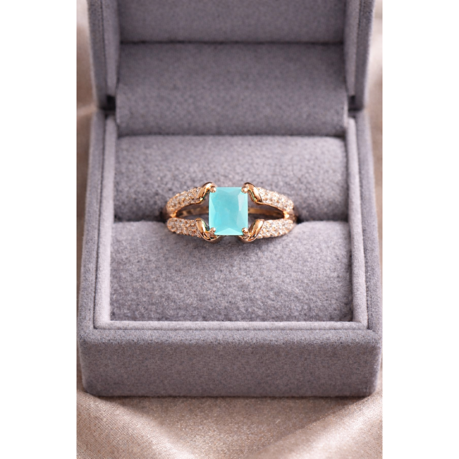 Gold aqua ring in a box