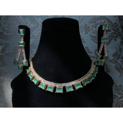 Jewelry set with necklace and earrings on a black stand against a patterned background