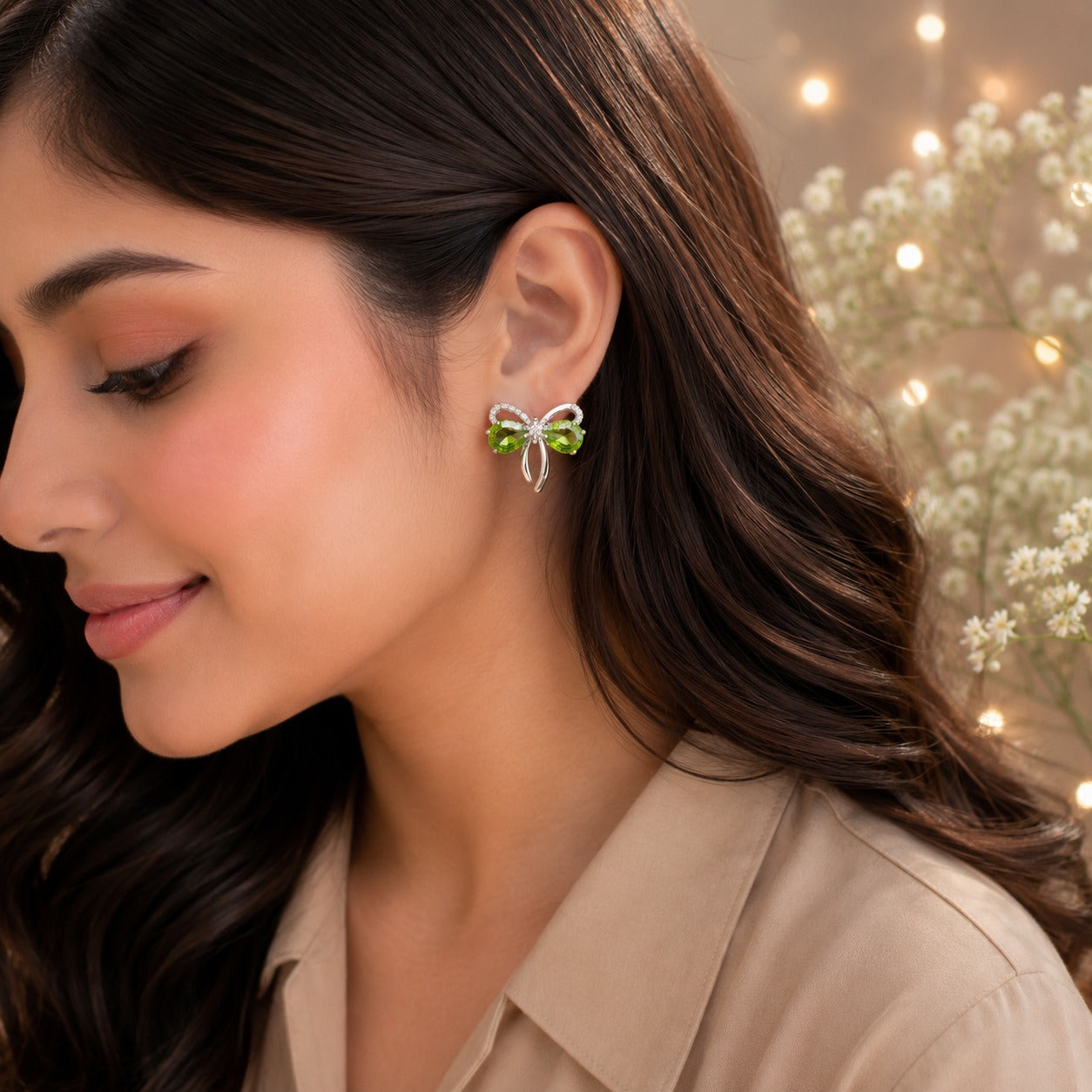 Olive green bow stud earrings worn by model with beige satin shirt.