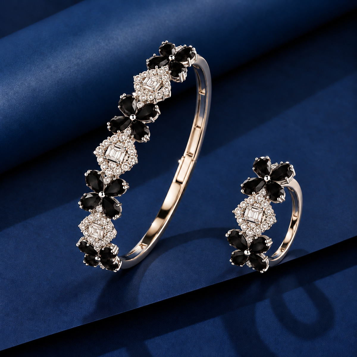 Jet black floral bracelet and matching ring with pear-cut gemstone petals, polished silver-tone metal and sparkling clear zircon accents.