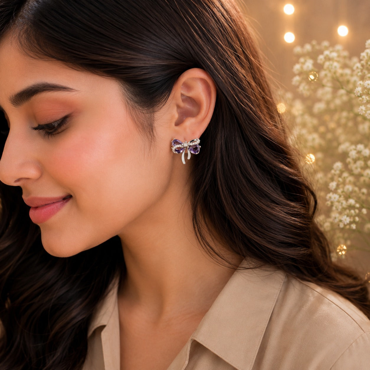 Lavender purple bow stud earrings worn by model with beige satin shirt.