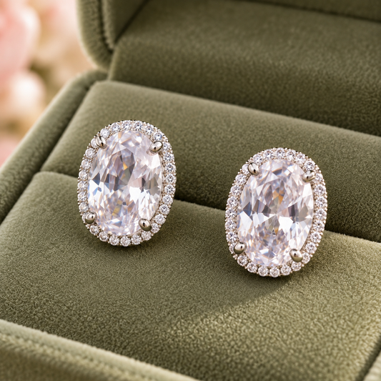 Oval halo crystal stud earrings in a sage green velvet jewellery box