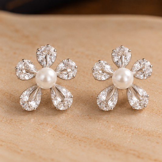 Elegant floral zircon and pearl earrings showcased on a  plate
