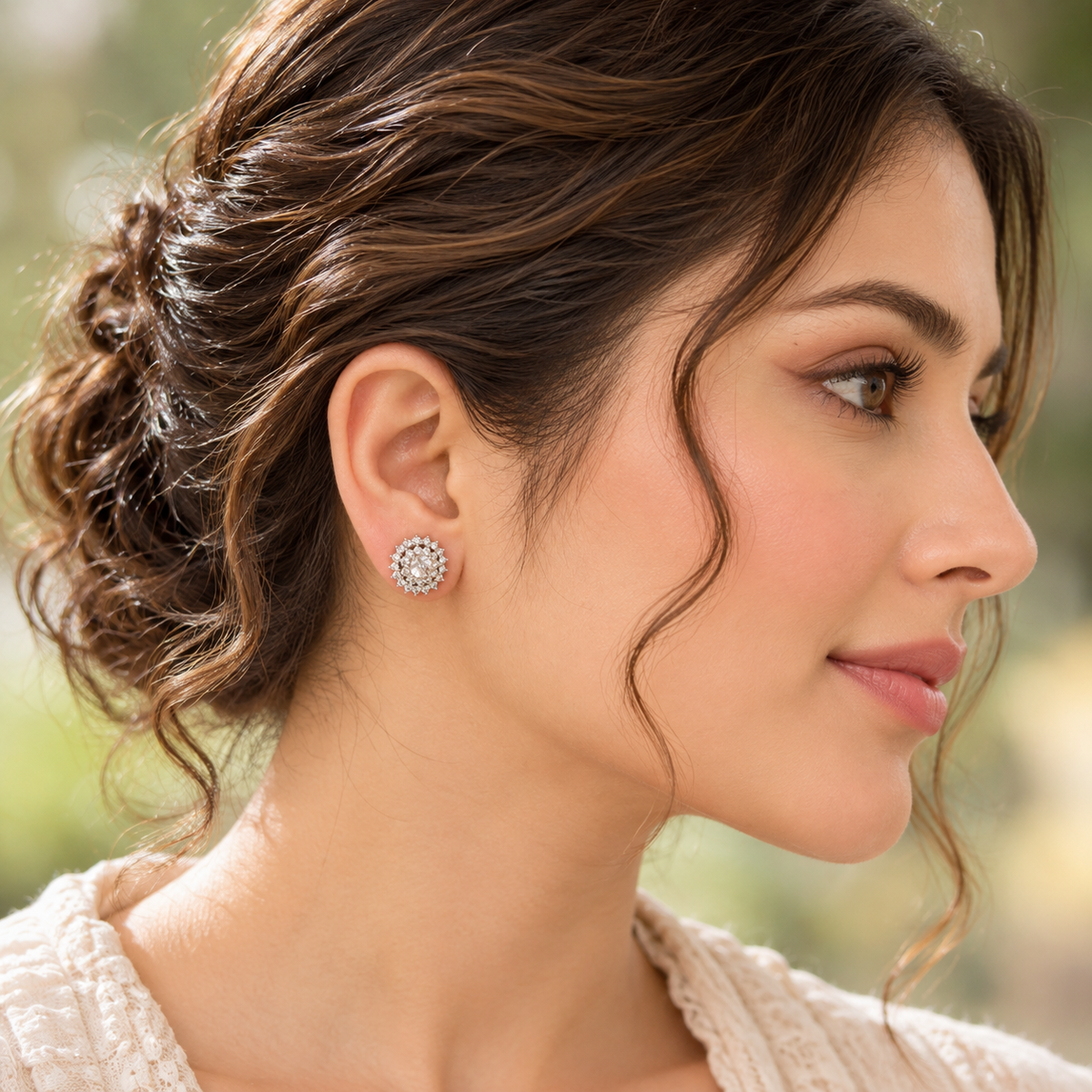   A woman's ear wearing a Kensington Cluster Stud, showcasing its delicate circular design and neat placement on the earlobe